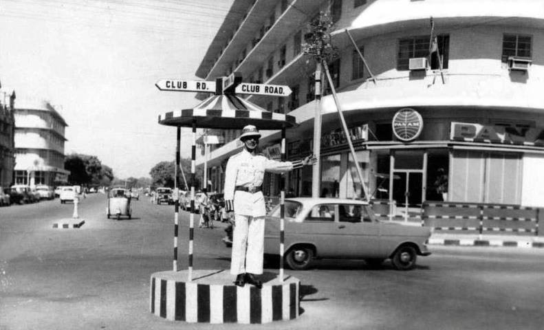 A traffic constable directing traffic near the famous Metropole Hotel in Karachi in 1960. Today the hotel serves as a wedding hall and parking lot