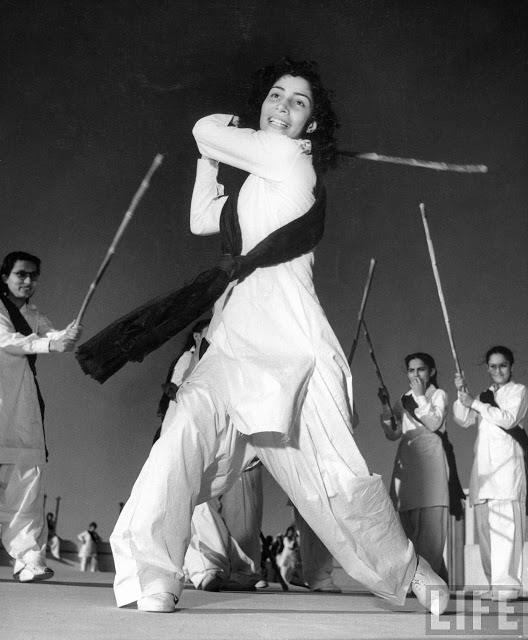 Pakistani members of the Sind Muslim Women’s National Guard practicing combat w. bamboo lathi sticks traditionally used by the Indian police – 1940’s