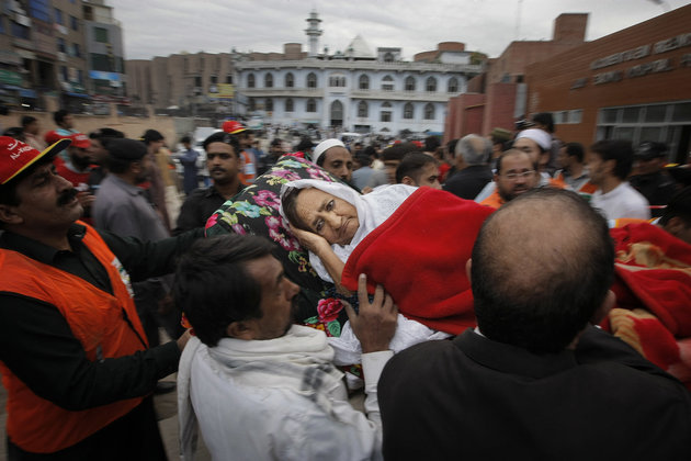 People rush an injured woman to a local hospital in Peshawar, Pakistan, Monday, Oct. 26, 2015. A powerful 7.7-magnitude earthquake in northern Afghanistan rocked cities across South Asia. Strong tremors were felt in Kabul, New Delhi and Islamabad on Monday. In the Pakistani capital, walls swayed back and forth and people poured out of office buildings in a panic, reciting verses from the Quran. (AP Photo/Mohammad Sajjad)