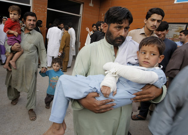 A man carries a child injured from an earthquake, in Peshawar, Pakistan, Monday, Oct. 26, 2015. A powerful 7.7-magnitude earthquake in northern Afghanistan rocked cities across South Asia. Strong tremors were felt in Kabul, New Delhi and Islamabad on Monday. In the Pakistani capital, walls swayed back and forth and people poured out of office buildings in a panic, reciting verses from the Quran. (AP Photo/Mohammad Sajjad)