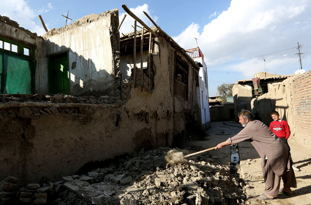 An Afghan man clears rubble from a damaged house following a strong earthquake, in Kabul, Afghanistan, Monday, Oct. 26, 2015. The U.S. Geological Survey said the epicenter of the 7.5-magnitude earthquake was in the Hindu Kush mountains, in the sparsely populated province of Badakhshan, which borders Pakistan, Tajikistan and China. It said the epicenter was 213 kilometers (130 miles) deep and 73 kilometers (45 miles) south of the provincial capital, Fayzabad. (AP Photo/Rahmat Gul)