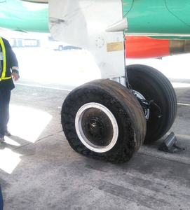 The tyre burst caused the plane to tilt on its side.
